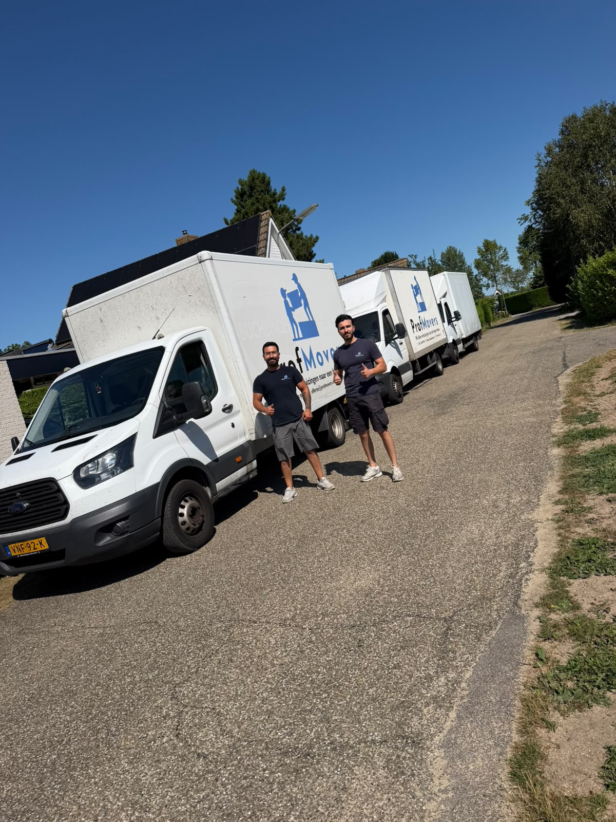 Het vaste verhuisteam van ProfMovers bij de eigen verhuiswagens voor aanvang van een verhuizing